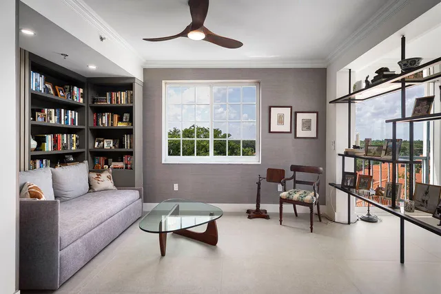 a living room with furniture and a book shelf