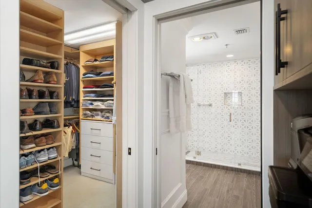 a view of walk in closet with empty racks