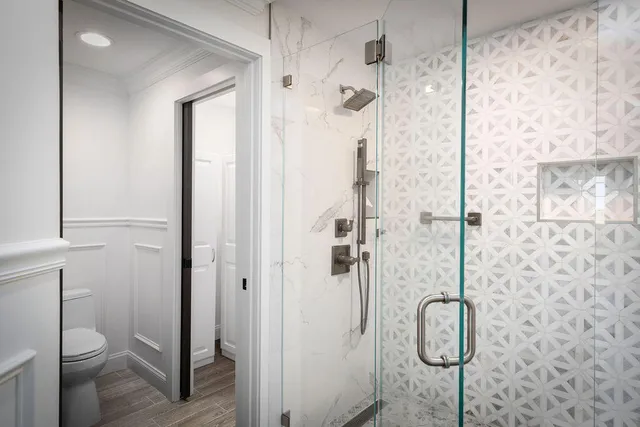 a bathroom with a shower toilet and sink