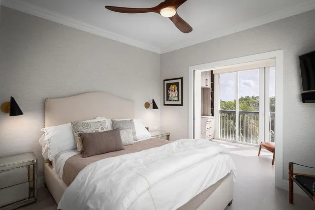 a bedroom with a large bed and a large window