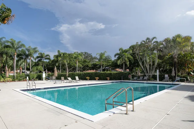 a view of a swimming pool and lounge chairs