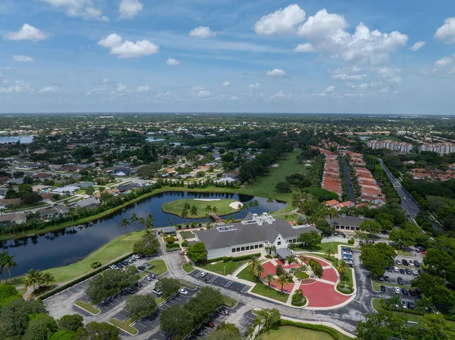 an aerial view of lake and residential houses with outdoor space