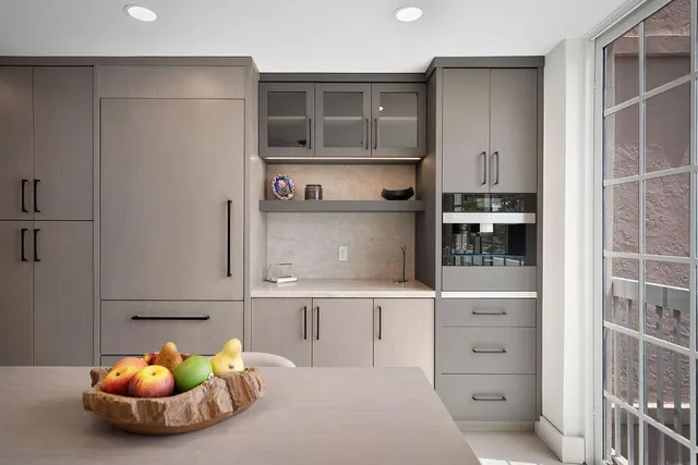 a room with wooden cabinets and shelf