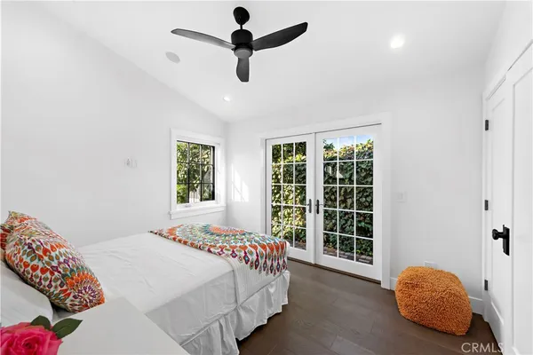 a bedroom with a bed and a large window