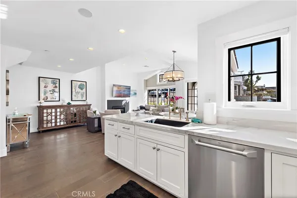 a kitchen that has a lot of cabinets and wooden floor
