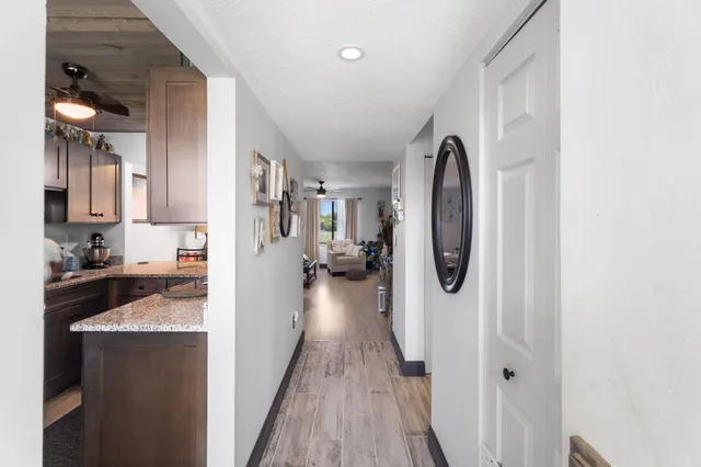 a view of a kitchen with a sink and wooden floor