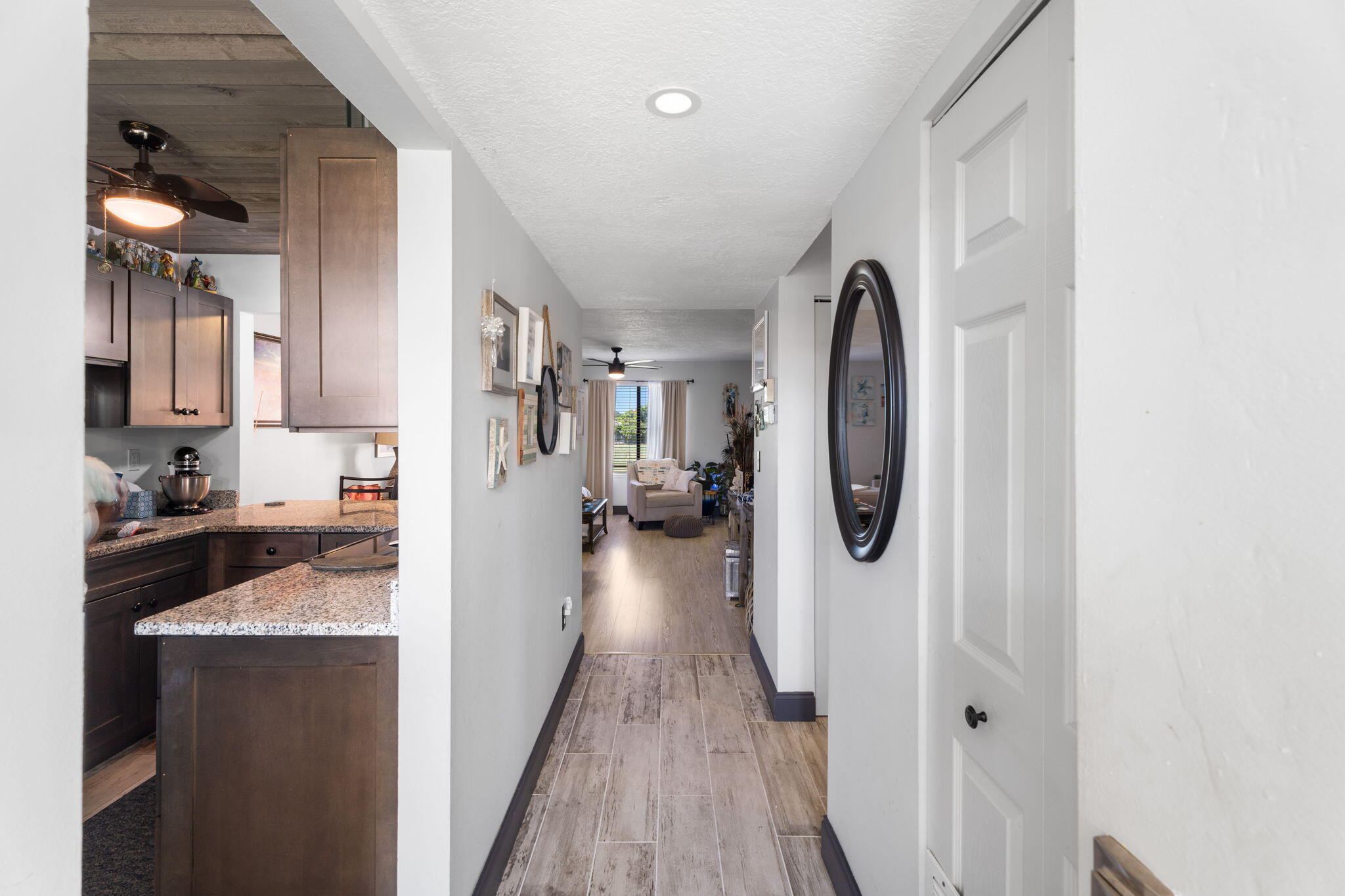 5383 Southeast Miles Grant Road, Unit B206 Stuart, FL 34997 - Photo 14 of 17 a view of a kitchen with a sink and wooden floor