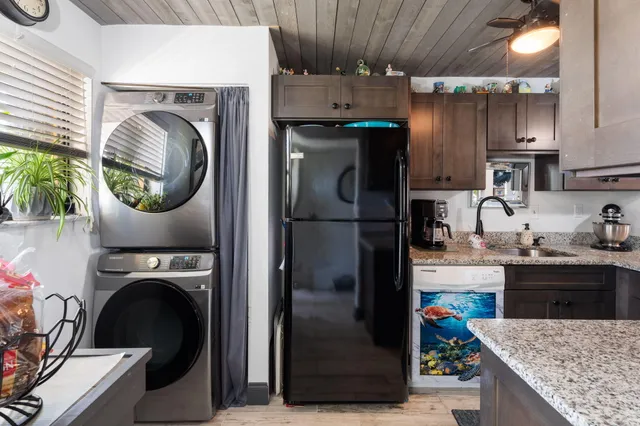 a kitchen with a refrigerator and a stove