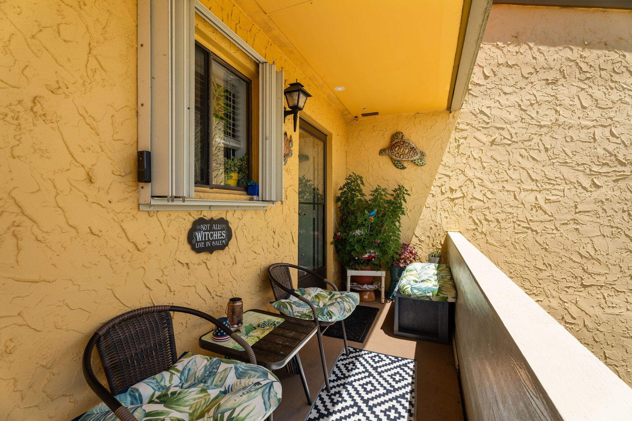 5383 Southeast Miles Grant Road, Unit B206 Stuart, FL 34997 - Photo 2 of 17 a balcony with furniture and wooden floor