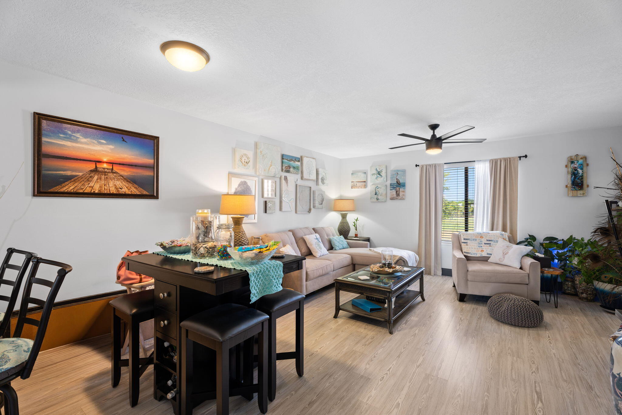 5383 Southeast Miles Grant Road, Unit B206 Stuart, FL 34997 - Photo 3 of 17 a living room with furniture and wooden floor