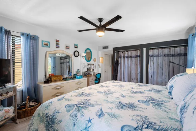 a bed room with a bed mirror and a window