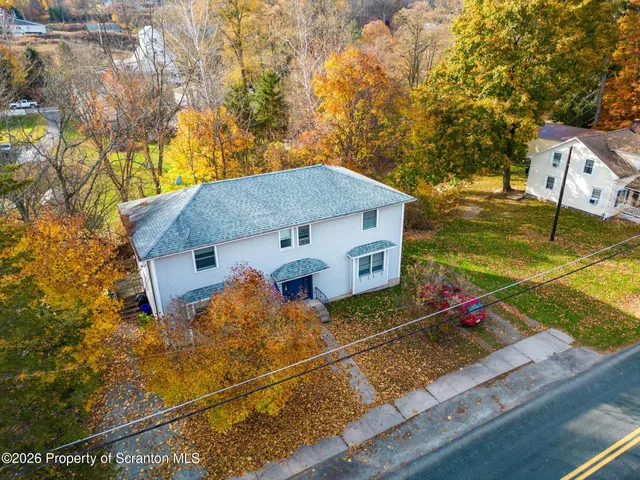 a large kitchen with a white stove top oven cabinets and a window
