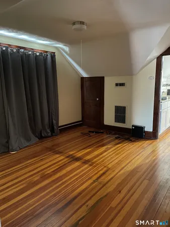 a view of a room with wooden floor