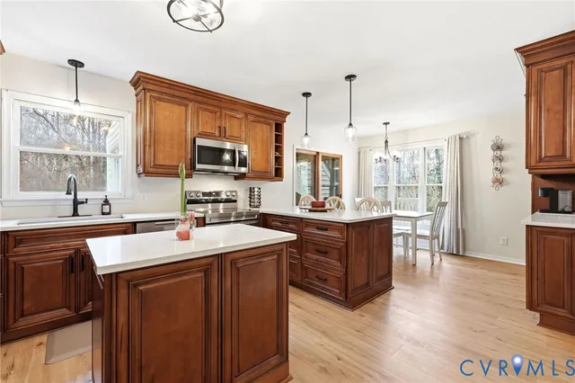 a kitchen with a sink stove top oven and microwave