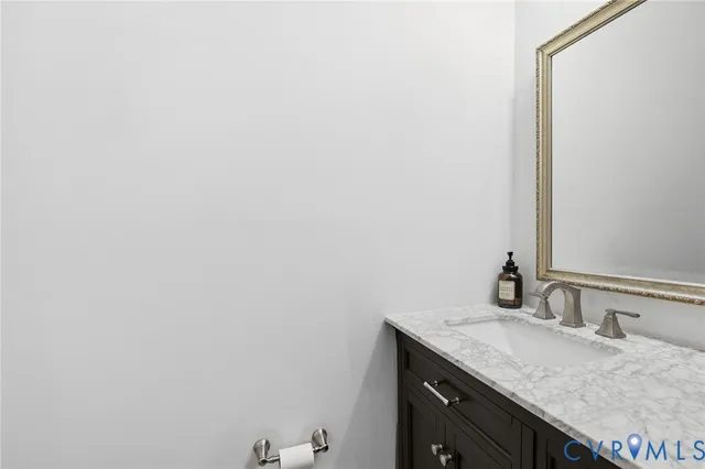 a bathroom with a granite countertop sink and vanity