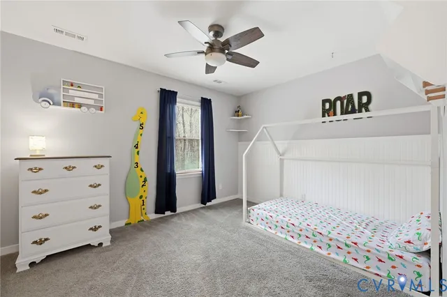 a view of a bedroom with bed and a ceiling fan