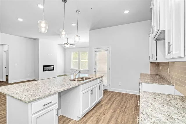 a view of a hallway view with wooden floor and staircase