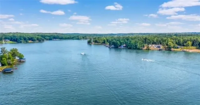a view of a lake with houses in the back