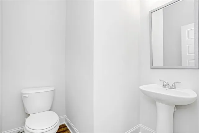 a large kitchen with a refrigerator and white cabinets