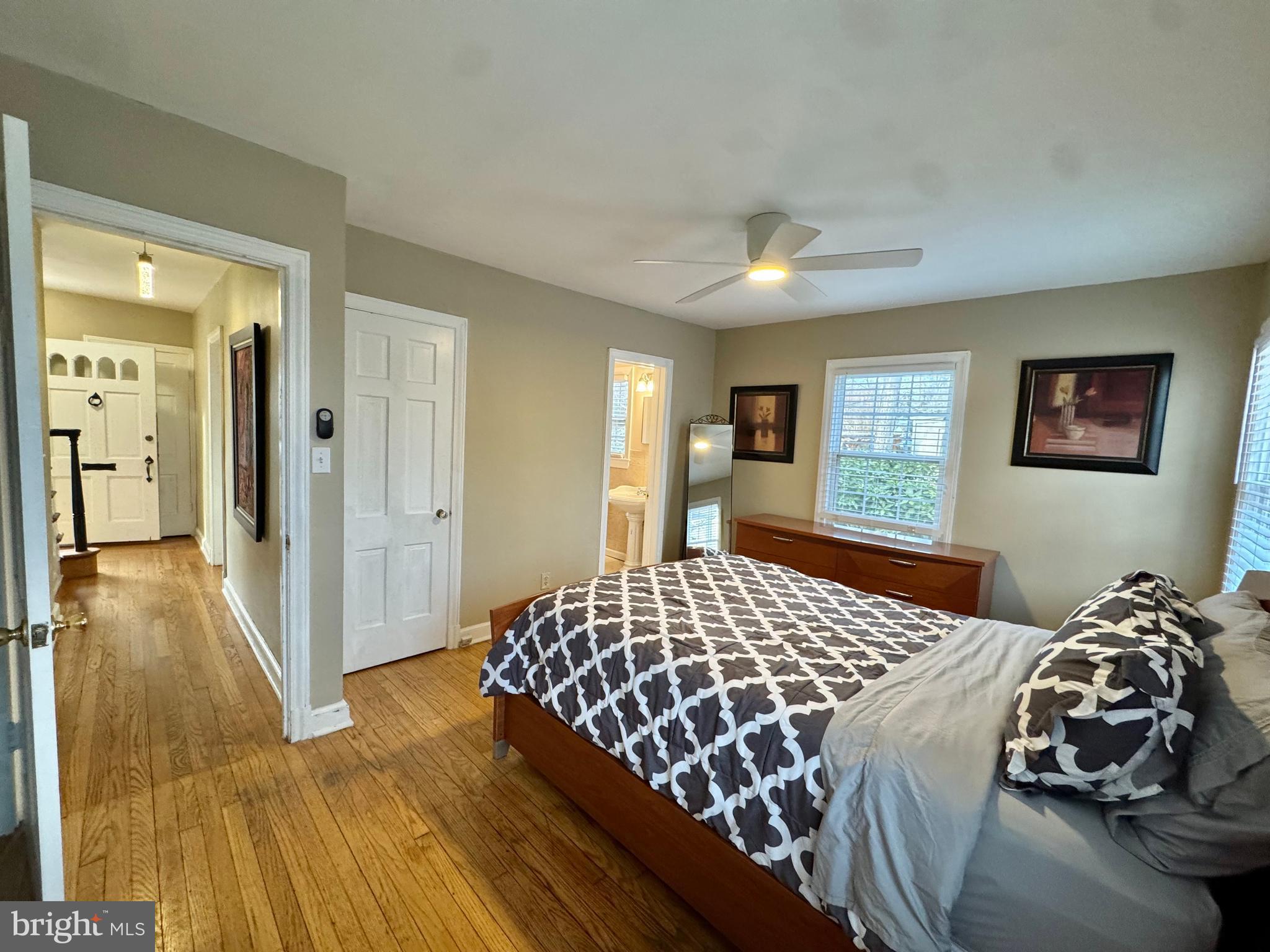 8815 Reading Road Silver Spring, MD 20901 - Photo 17 of 56 a bedroom with a bed and a chandelier