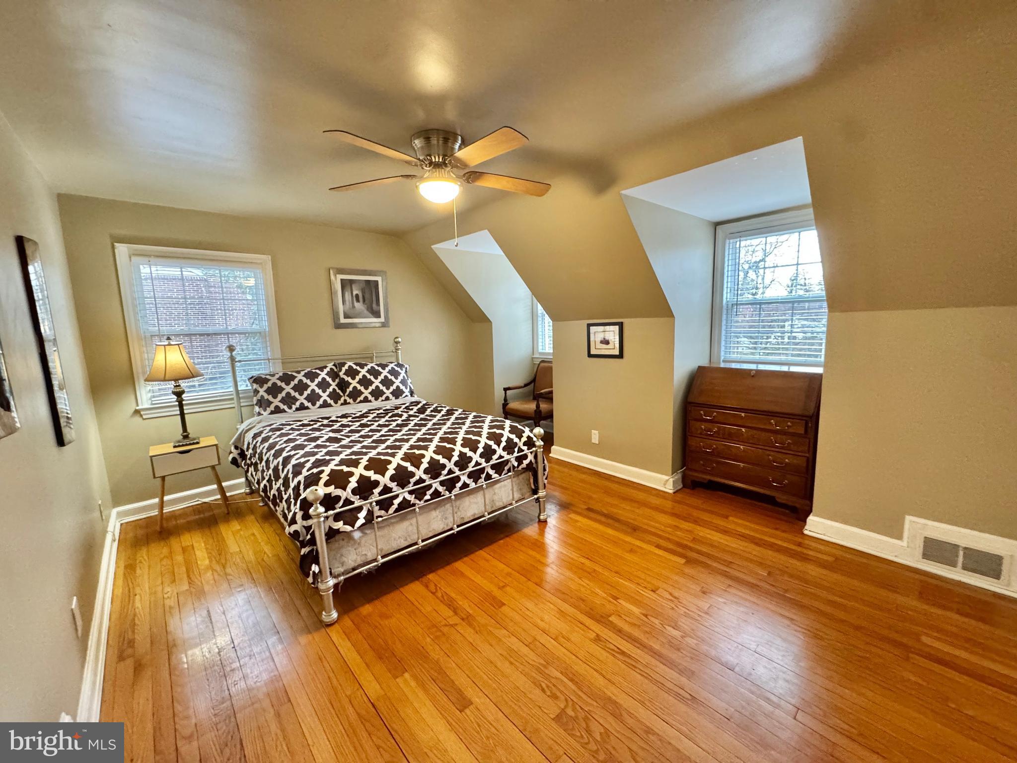 8815 Reading Road Silver Spring, MD 20901 - Photo 30 of 56 a bedroom with a bed and wooden floor