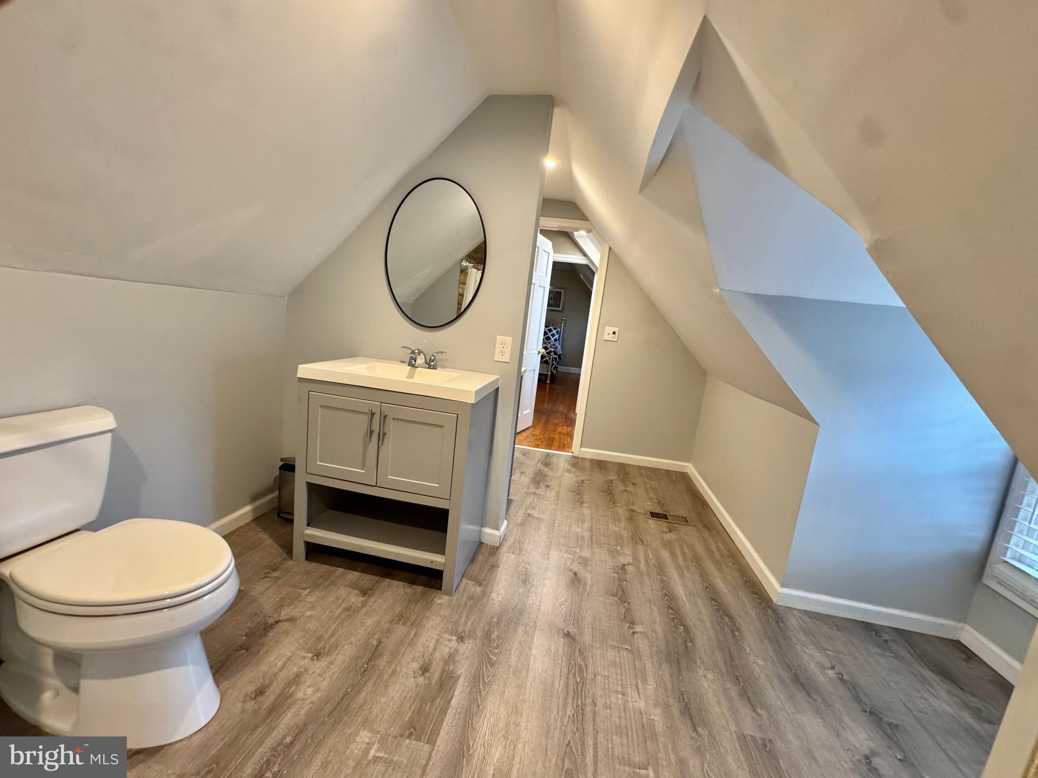 8815 Reading Road Silver Spring, MD 20901 - Photo 37 of 56 a bathroom with a toilet a sink and mirror