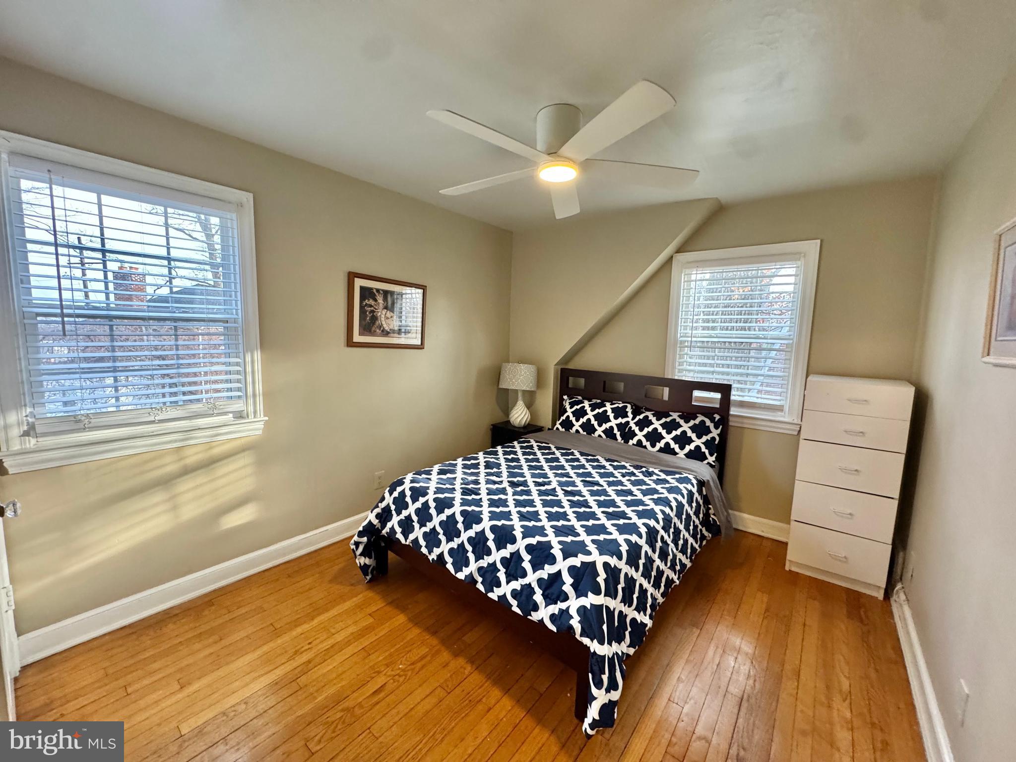 8815 Reading Road Silver Spring, MD 20901 - Photo 39 of 56 a bedroom with a bed and wooden floor