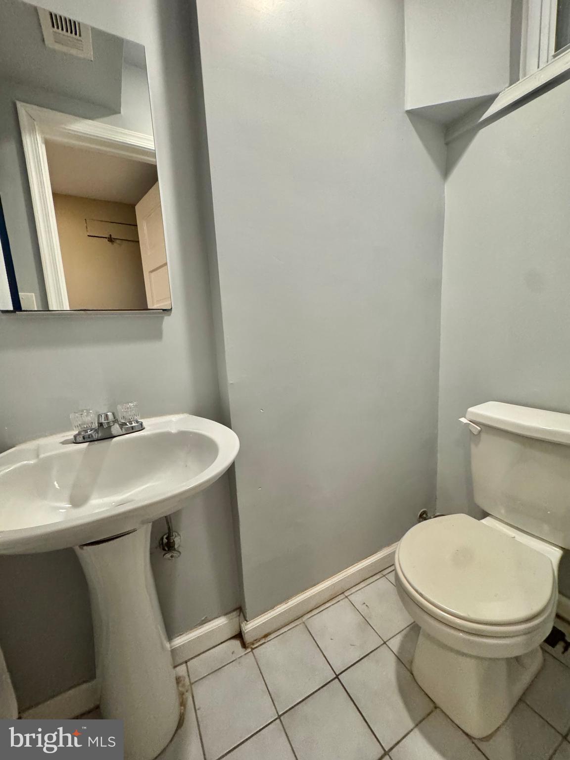 8815 Reading Road Silver Spring, MD 20901 - Photo 49 of 56 a bathroom with a sink toilet and mirror