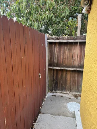 a wooden door in front of a wooden fence