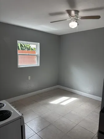 a view of empty room with ceiling fan