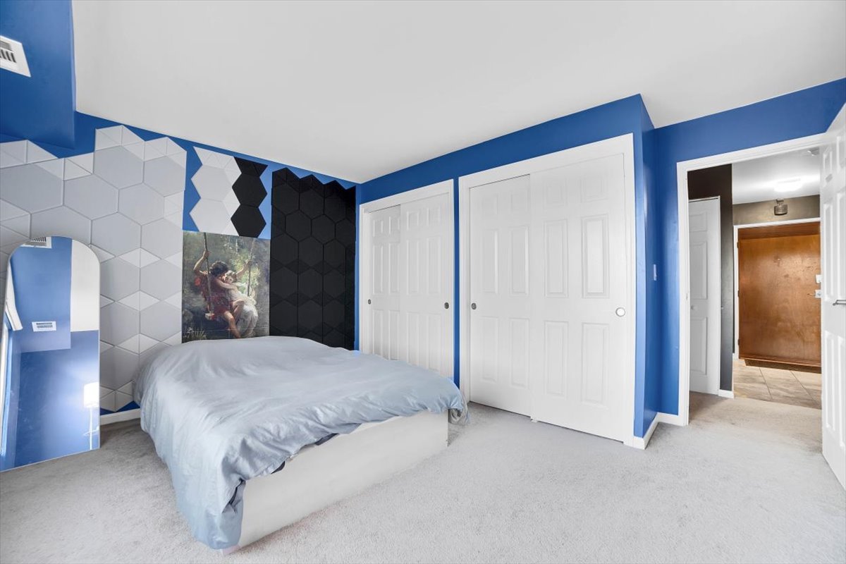 500 West Huntington Commons Road, Unit 448 Mount Prospect, IL 60056 - Photo 12 of 26 a spacious bedroom with a bed and a cabinets