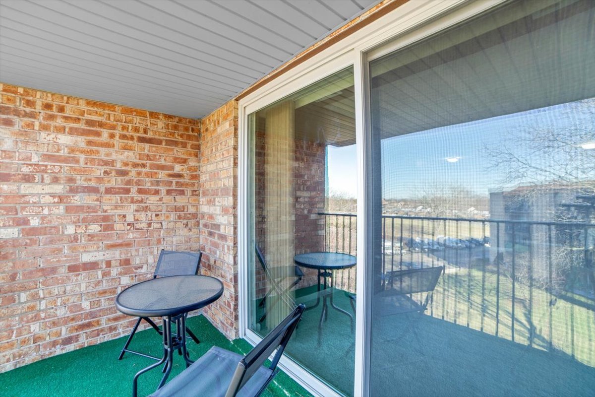 500 West Huntington Commons Road, Unit 448 Mount Prospect, IL 60056 - Photo 19 of 26 a balcony with chairs and a table