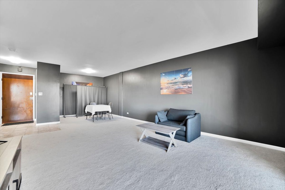 500 West Huntington Commons Road, Unit 448 Mount Prospect, IL 60056 - Photo 5 of 26 a room with furniture and air hockey table