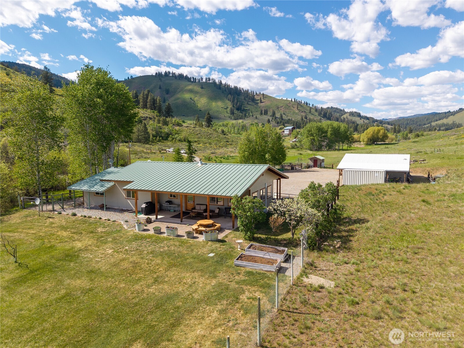 446 Rendezvous Road Winthrop, WA 98862 - Photo 2 of 40 a view of a swimming pool with a yard