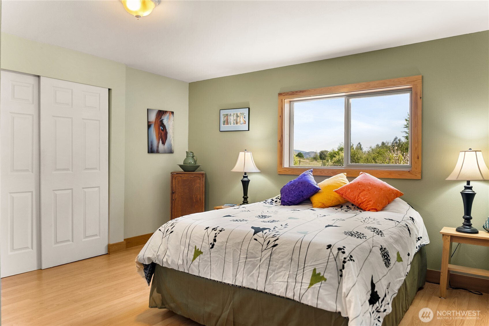 446 Rendezvous Road Winthrop, WA 98862 - Photo 21 of 40 a bedroom with a bed and wooden floor