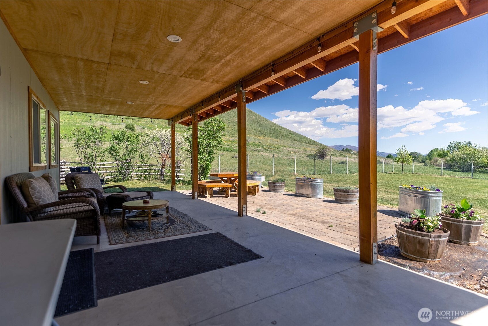 446 Rendezvous Road Winthrop, WA 98862 - Photo 28 of 40 a living room with patio furniture and a floor to ceiling window