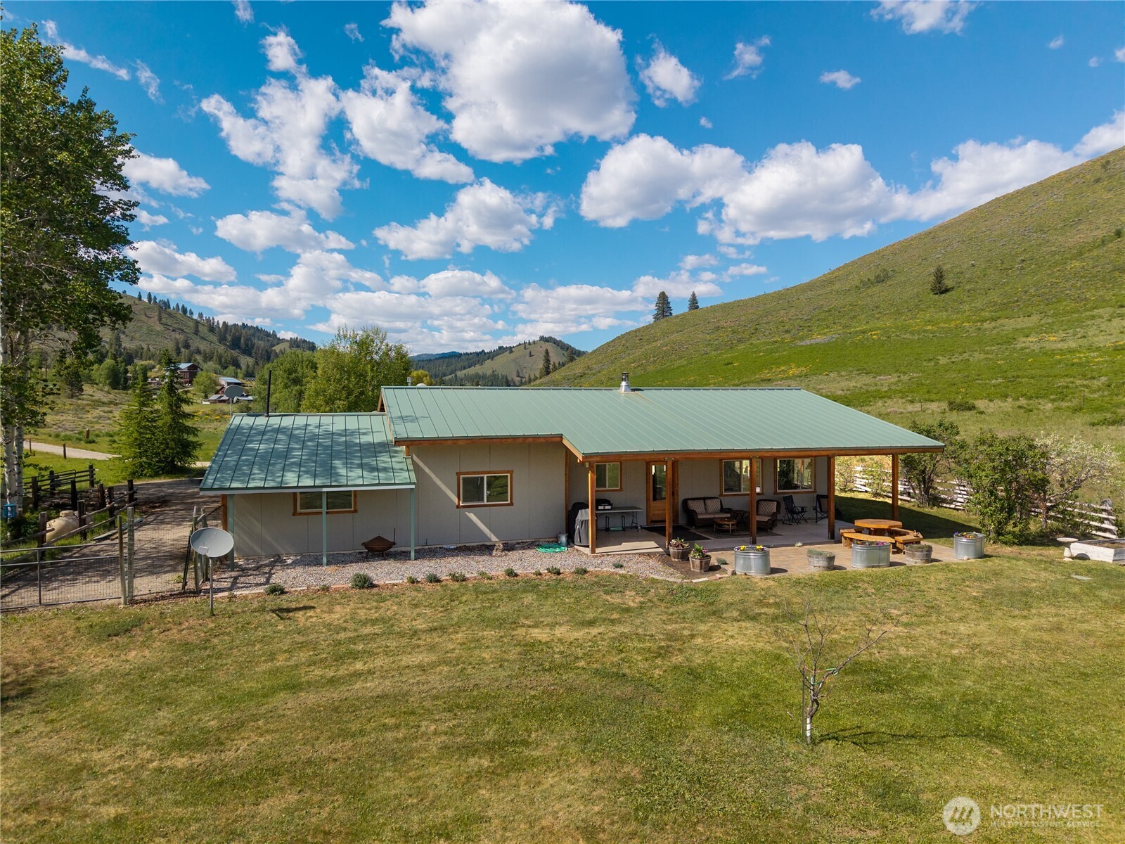 446 Rendezvous Road Winthrop, WA 98862 - Photo 31 of 40 a roof deck with table and chairs under an umbrella