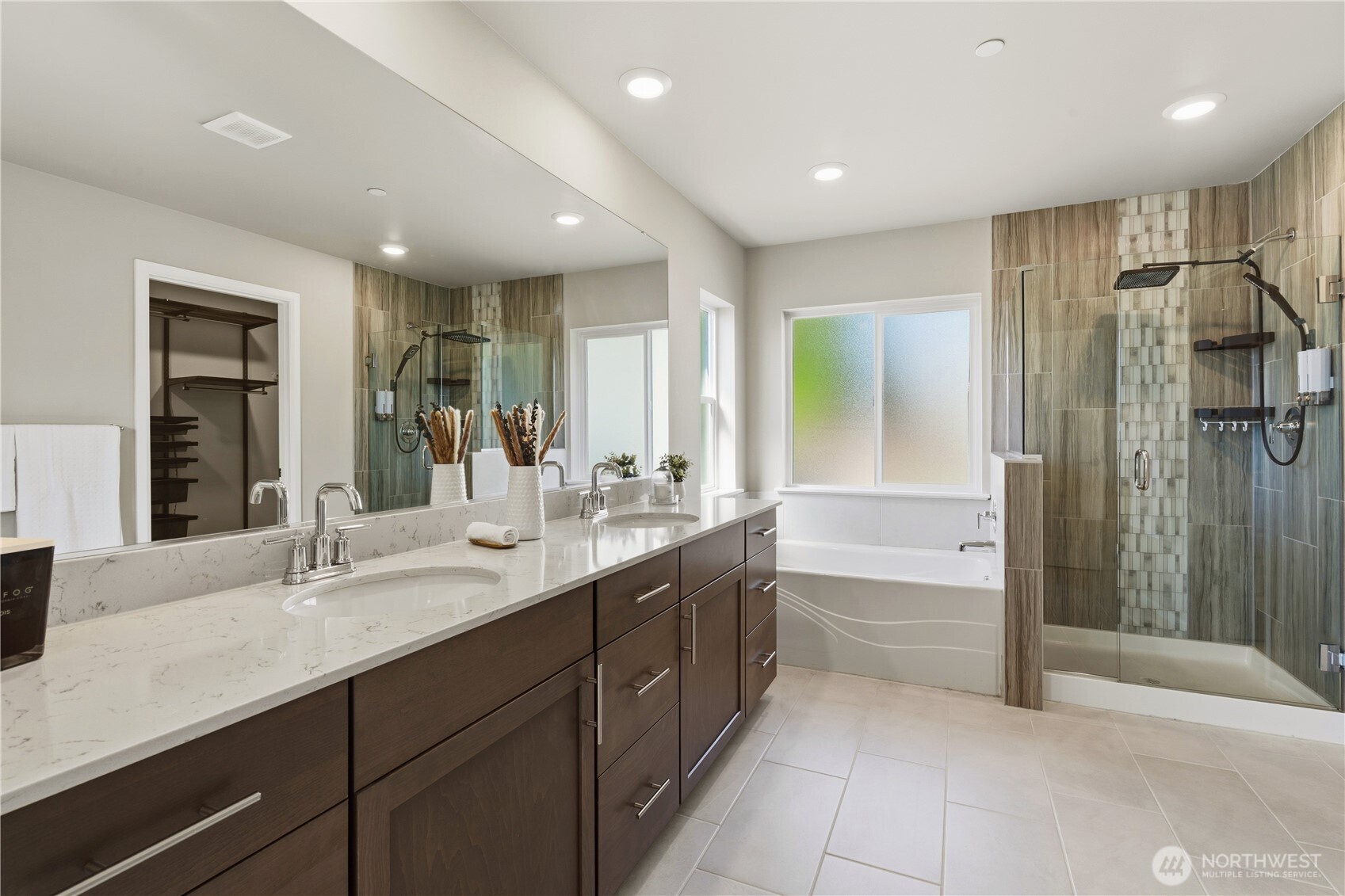 19432 9th Avenue Southeast Bothell, WA 98012 - Photo 18 of 33 a bathroom with a double vanity sink a large mirror a shower and bathtub
