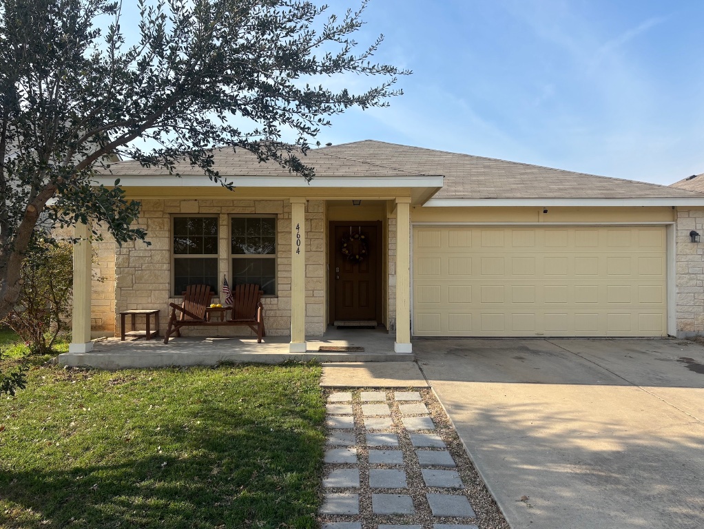 4604 Cleto Street Austin, TX 78725 - Photo 1 of 1 View of front of home featuring a shingled roof, stone siding, concrete driveway, a porch, and a front yard