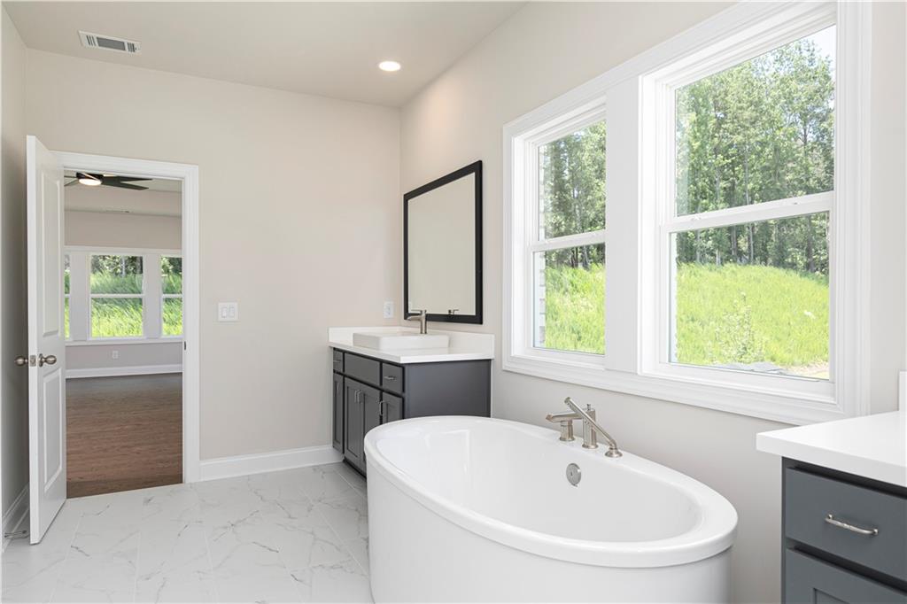2475 Stewart Road Cumming, GA 30041 - Photo 21 of 30 a bathroom with a sink and a window