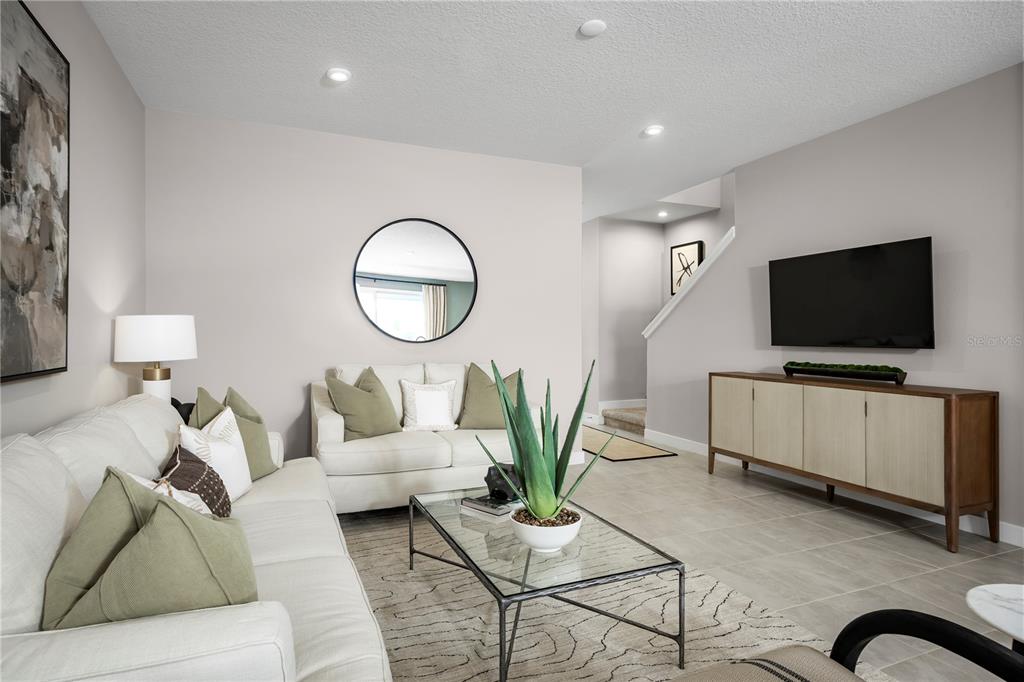 31590 Spanish Msn Road San Antonio, FL 33576 - Photo 4 of 26 a living room with furniture and a flat screen tv