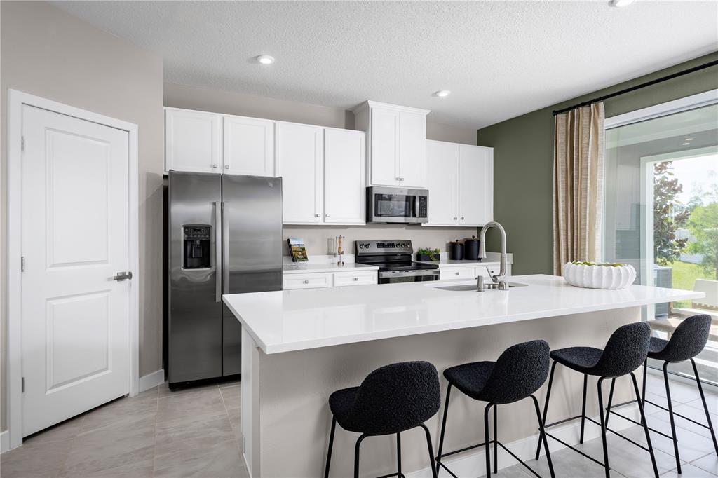 31590 Spanish Msn Road San Antonio, FL 33576 - Photo 8 of 26 a kitchen with appliances a sink and cabinets
