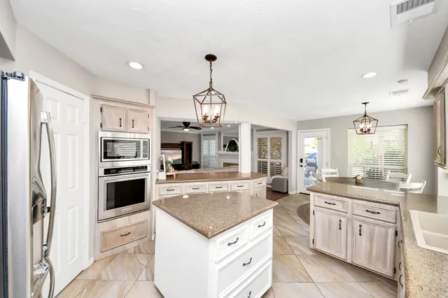 a spacious bathroom with a double vanity sink a mirror and a bathtub