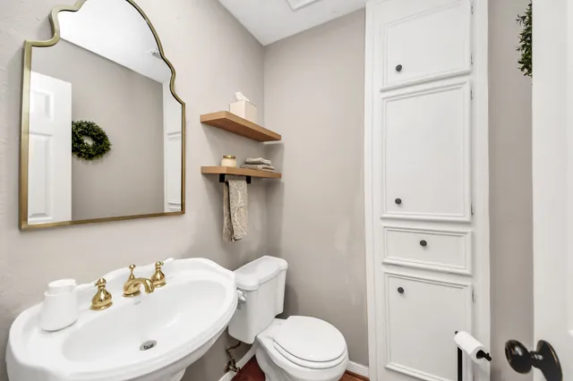 a living room with furniture and a flat screen tv with wooden floor