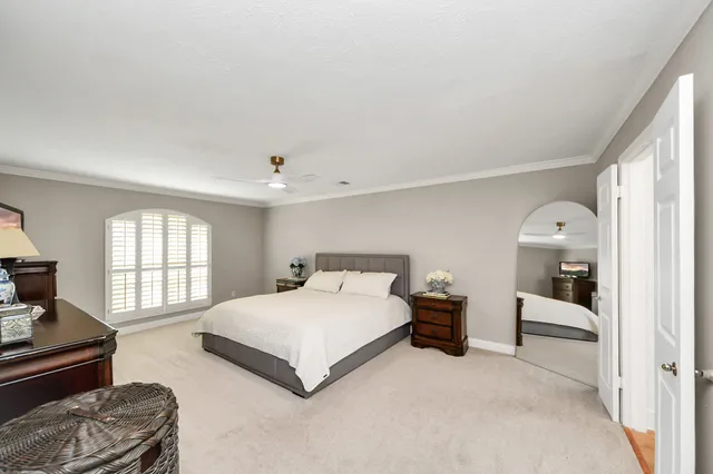 a bedroom with a large bed and a chandelier