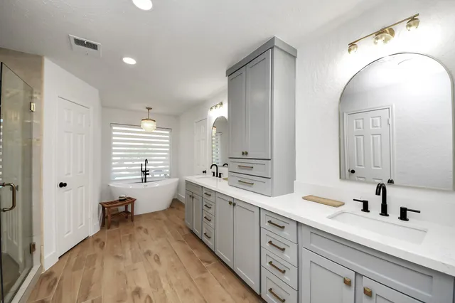 a spacious bedroom with a bed and a chandelier