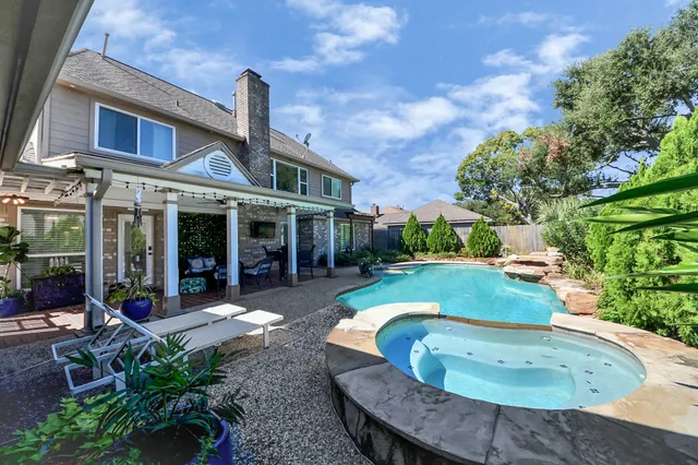 a living room with furniture flat screen tv and a large window