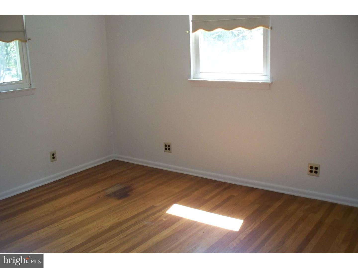 207 Spruce Road Flourtown, PA 19031 - Photo 11 of 19 a view of an empty room with wooden floor and a window