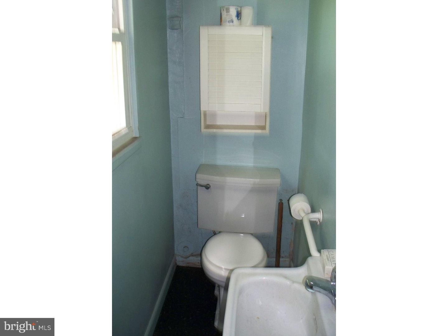 207 Spruce Road Flourtown, PA 19031 - Photo 19 of 19 a white toilet sitting in a bathroom next to a sink