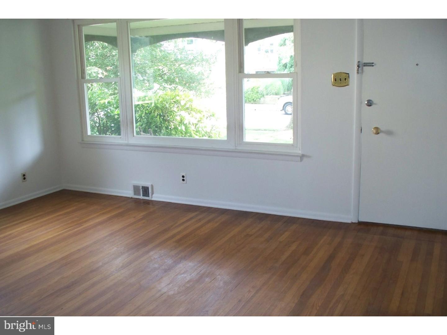 207 Spruce Road Flourtown, PA 19031 - Photo 4 of 19 a view of an empty room with wooden floor and a window